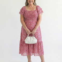 Odette off-shoulder floral smocked midi dress by THE WHITMORE FAMILY, featuring a flowy midi length and feminine floral print.