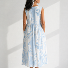 Multicolor Joy™ Leafy sleeveless midi dress by THE WHITMORE FAMILY, featuring a vibrant leaf pattern and a flowing midi length.
