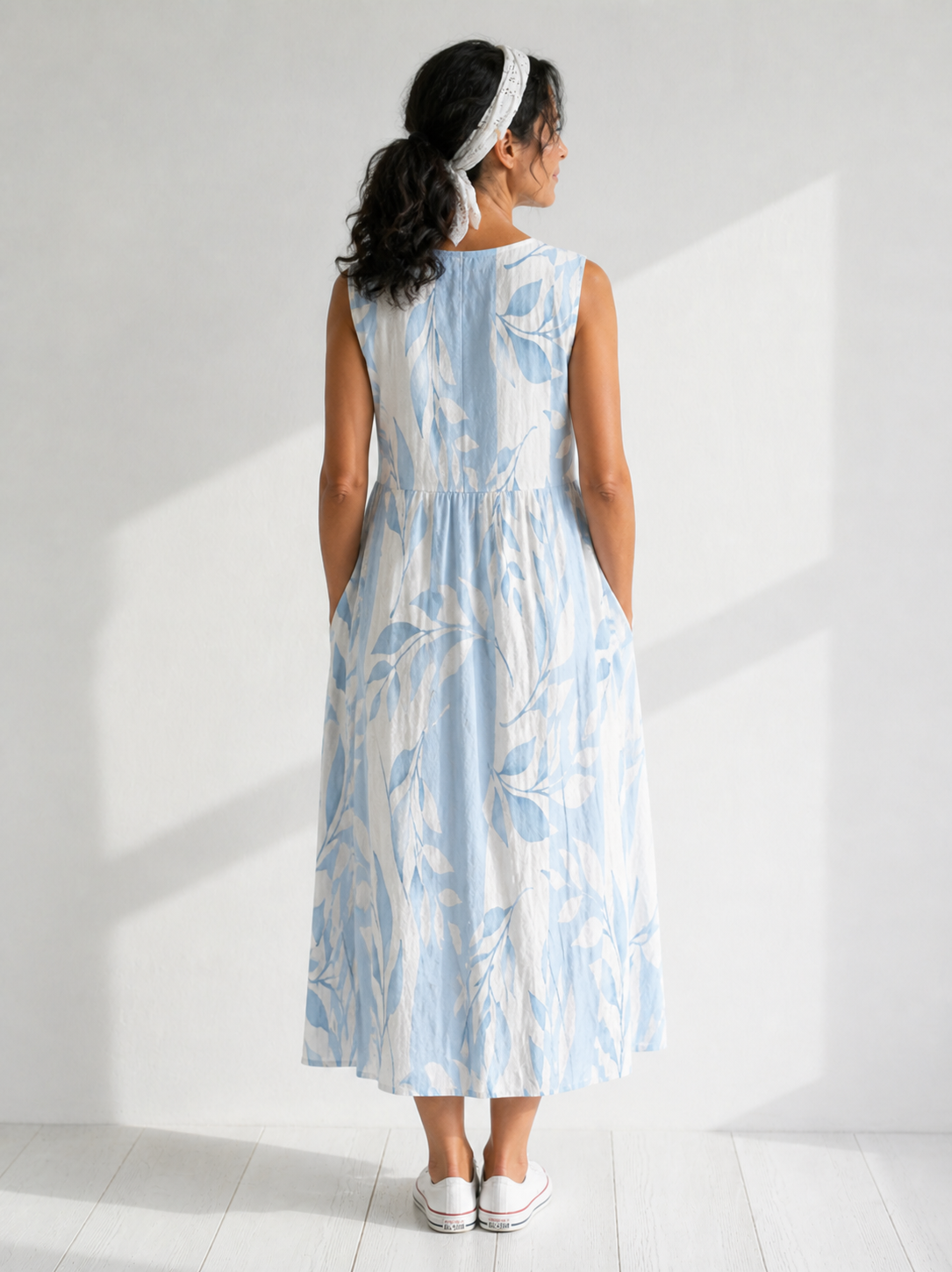 Multicolor Joy™ Leafy sleeveless midi dress by THE WHITMORE FAMILY, featuring a vibrant leaf pattern and a flowing midi length.