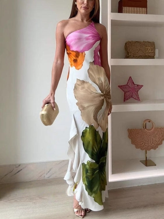 Multi-colored floral maxi dress by THE WHITMORE FAMILY featuring vibrant floral patterns and flowing fabric.