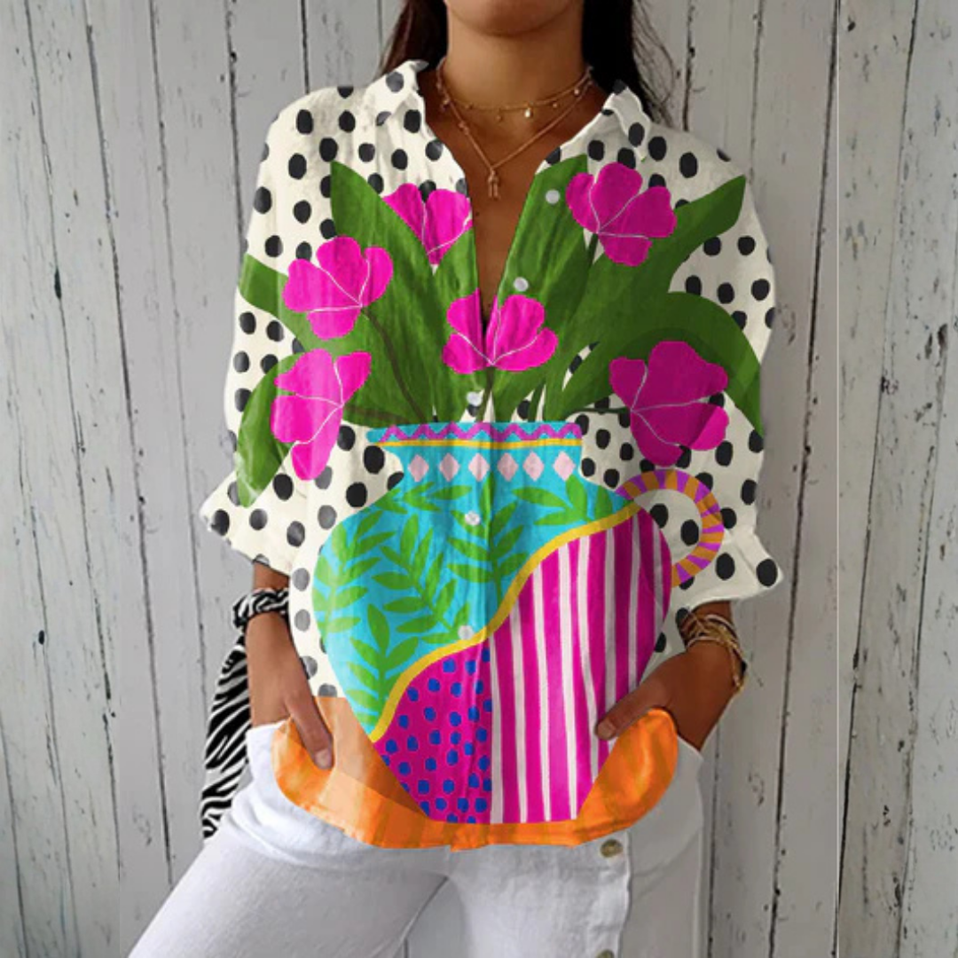 Donna™ Blooming Vase Blouse by THE WHITMORE FAMILY features multicolor floral patterns and lightweight fabric.