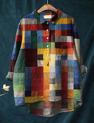 Multicolor Iris color block print shirt by THE WHITMORE FAMILY displayed on a hanger, showcasing vibrant, geometric fabric pattern.