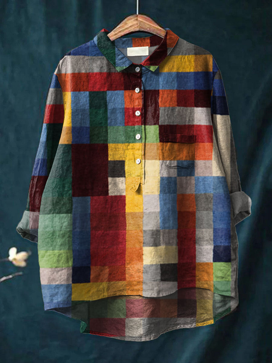 Multicolor Iris color block print shirt by THE WHITMORE FAMILY displayed on a hanger, showcasing vibrant, geometric fabric pattern.