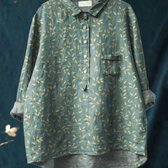 Vibrant floral embroidered shirt by THE WHITMORE FAMILY, featuring colorful floral patterns on a lightweight fabric.