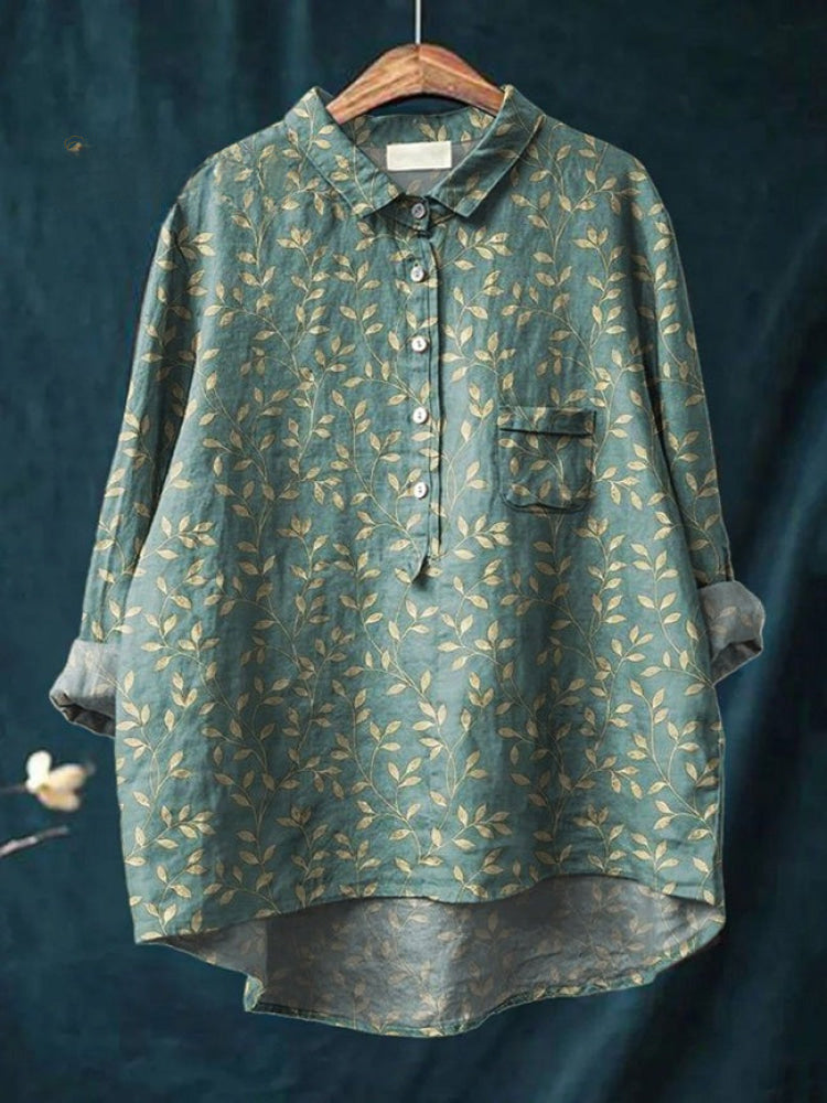Vibrant floral embroidered shirt by THE WHITMORE FAMILY, featuring colorful floral patterns on a lightweight fabric.