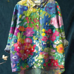 Vibrant floral embroidered shirt by THE WHITMORE FAMILY featuring colorful floral patterns on a lightweight fabric.