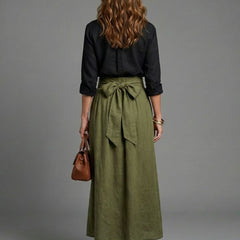 Vera two-piece set by THE WHITMORE FAMILY featuring a black blouse and olive green midi skirt, displayed on a model.