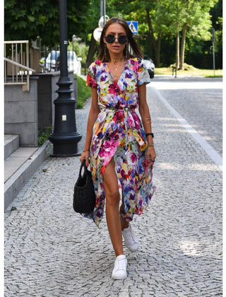 Multicolored floral V-neck dress by THE WHITMORE FAMILY, stylish and lightweight, displayed on a hanger.