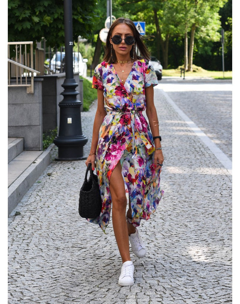 Multicolored floral V-neck dress by THE WHITMORE FAMILY, stylish and lightweight, displayed on a hanger.