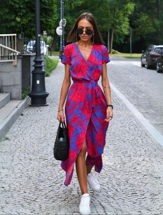 Multicolored floral V-neck dress by THE WHITMORE FAMILY, featuring a stylish design and flowing fabric.