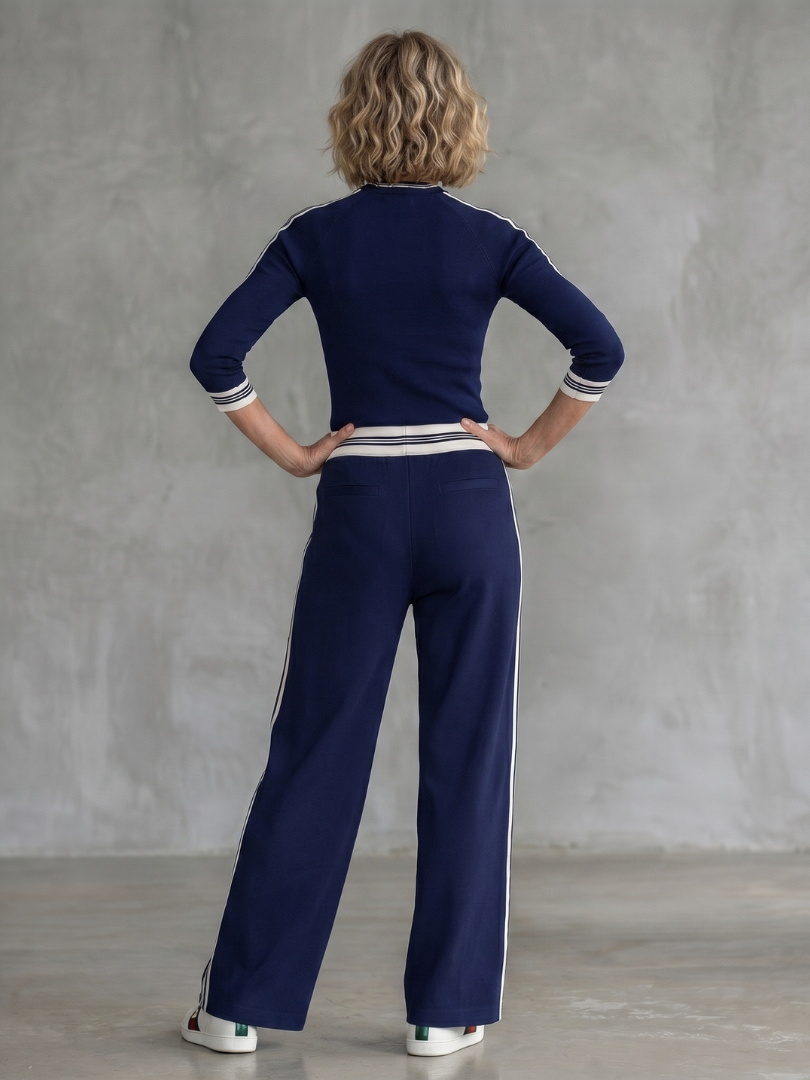 Navy Eirlys fitted long sleeve top and wide-leg pants set by THE WHITMORE FAMILY displayed on a model.