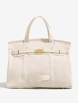 The Camille Boat Tote by THE WHITMORE FAMILY, beige canvas tote with leather handles and durable design for everyday use.