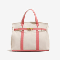 The Camille Boat Tote by THE WHITMORE FAMILY, showing a stylish fabric tote with leather handles and spacious interior.