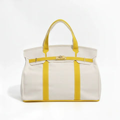Sunny yellow Camille Boat Tote by THE WHITMORE FAMILY with sturdy handles and spacious interior for everyday use.