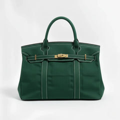 Dark green Camille Boat Tote by THE WHITMORE FAMILY featuring sturdy canvas material and leather handles.
