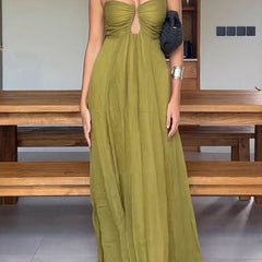 Stylish green guest dress by THE WHITMORE FAMILY with elegant design, perfect for formal events and gatherings.