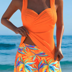 Orange Abigail® stylish tankini with tropical skirt, featuring vibrant pattern and comfortable fit for beach or poolside wear.