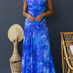 Pink printed maxi dress by THE WHITMORE FAMILY featuring elegant floral patterns and a flowing silhouette.
