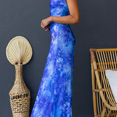 Pink printed maxi dress by THE WHITMORE FAMILY featuring elegant floral patterns and flowing fabric.