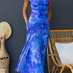 Pink Diana elegant printed maxi dress by THE WHITMORE FAMILY, flowing fabric, floral pattern, and stylish design.