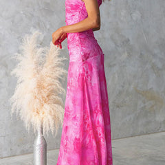Pink printed maxi dress by THE WHITMORE FAMILY featuring elegant floral patterns and flowing fabric.