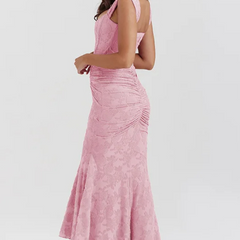 Elegant pink wedding dress named Gloria by THE WHITMORE FAMILY, featuring a flowing silhouette and intricate lace details.