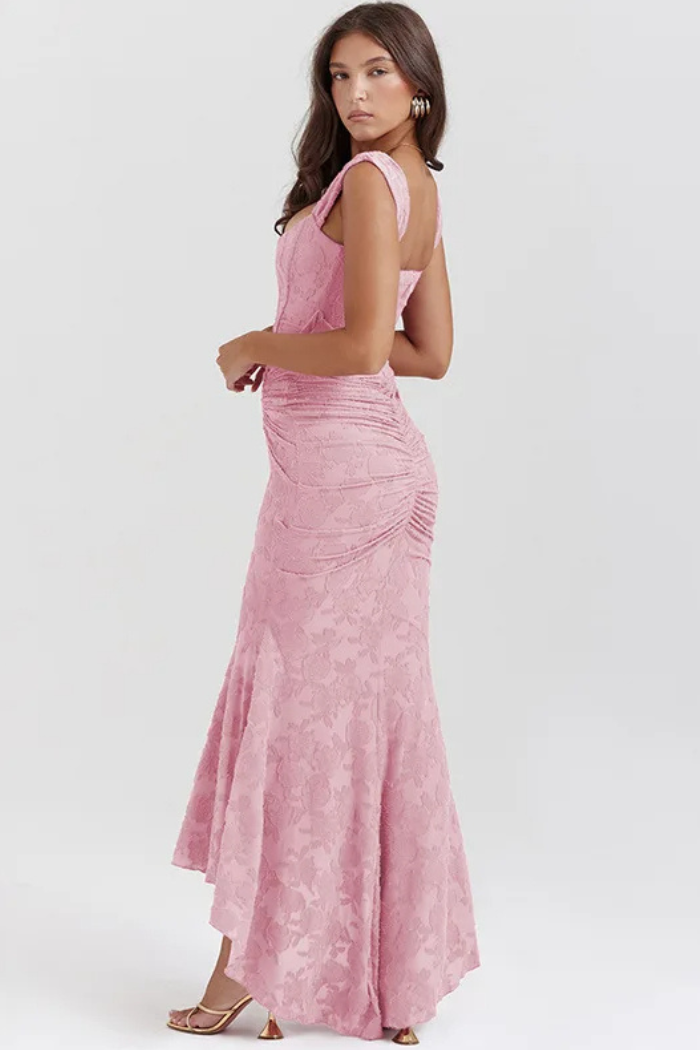 Elegant pink wedding dress named Gloria by THE WHITMORE FAMILY, featuring a flowing silhouette and intricate lace details.