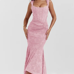 Elegant pink wedding dress named Gloria by THE WHITMORE FAMILY, featuring intricate lace details and a flowing train.