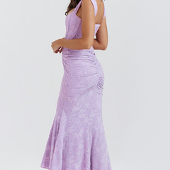 Elegant pink wedding dress named Gloria by THE WHITMORE FAMILY, featuring intricate lace details and a flowing train.
