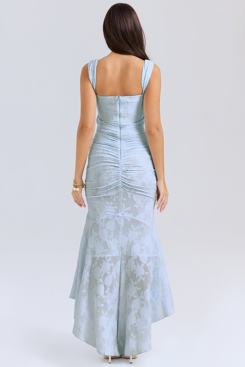 Elegant pink wedding dress named Gloria by THE WHITMORE FAMILY featuring intricate lace details and a flowing train.
