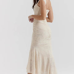 Elegant pink wedding dress named Gloria by THE WHITMORE FAMILY, featuring intricate lace and a flowing train.