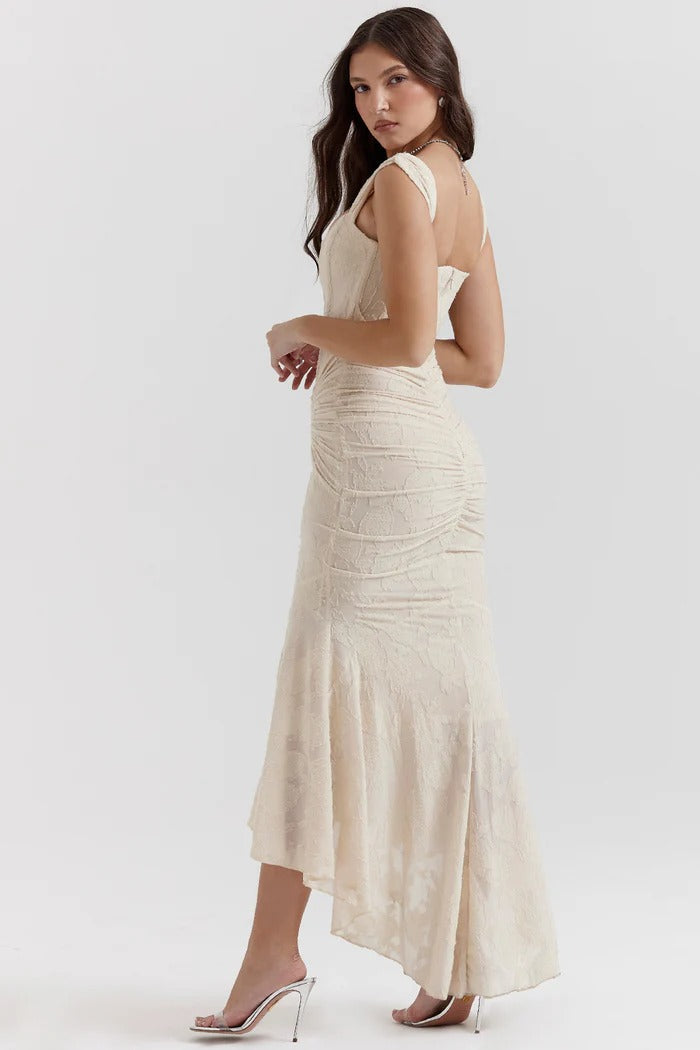 Elegant pink wedding dress named Gloria by THE WHITMORE FAMILY, featuring intricate lace and a flowing train.