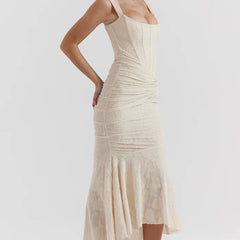Elegant pink wedding dress named Gloria by THE WHITMORE FAMILY, featuring intricate lace details and a flowing train.
