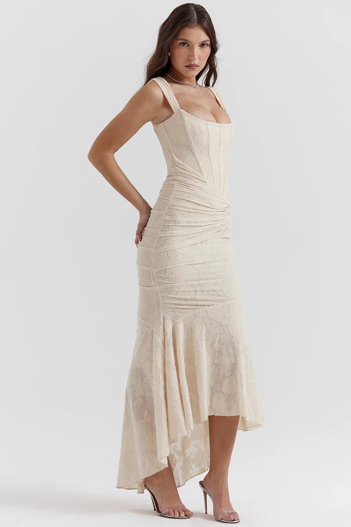 Elegant pink wedding dress named Gloria by THE WHITMORE FAMILY, featuring intricate lace details and a flowing train.