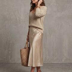 Pink bias fall satin skirt and knit layered set from THE WHITMORE FAMILY's Luciana collection, featuring a stylish, cozy outfit ensemble.