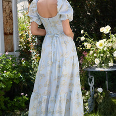 Pink Layla elegant flowing dress by THE WHITMORE FAMILY, featuring soft fabric and a graceful silhouette.