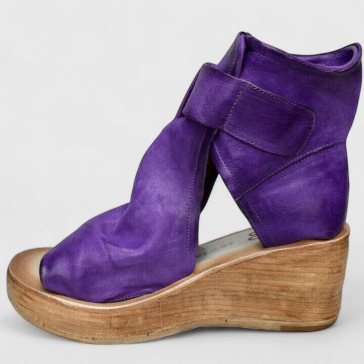 Purple Jess™ orthopedic wedge sandals by THE WHITMORE FAMILY with cushioned footbed and ankle straps for comfort.