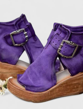 Purple Jess™ orthopedic wedge sandals by THE WHITMORE FAMILY with cushioned straps and supportive soles.
