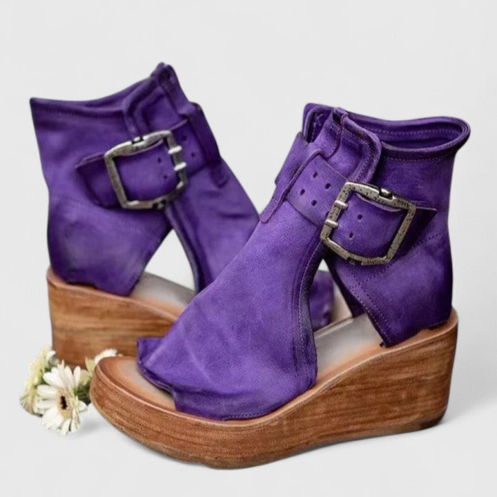 Purple Jess™ orthopedic wedge sandals by THE WHITMORE FAMILY with cushioned straps and supportive soles.