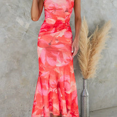 Purple floral one-shoulder dress by THE WHITMORE FAMILY, featuring a flowing design and vibrant floral pattern.