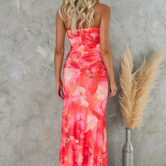 Purple floral one-shoulder dress by THE WHITMORE FAMILY, featuring a fitted bodice and flowing skirt with vibrant floral pattern.