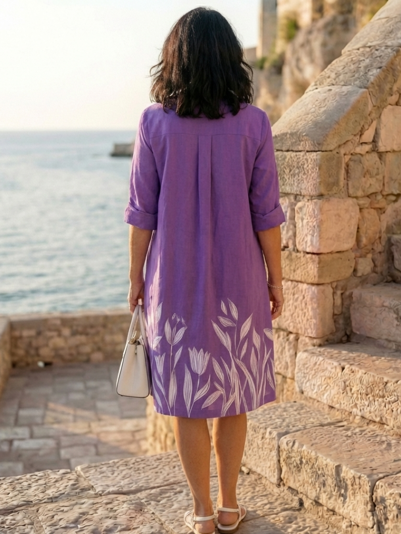 Purple Galatea evening garden walk dress by THE WHITMORE FAMILY, flowing fabric and floral design perfect for elegant occasions.