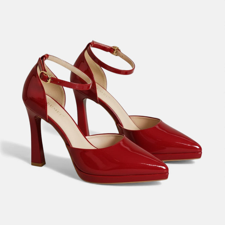 Red leather Evette heels by THE WHITMORE FAMILY with pointed toes and stylish stiletto heels, perfect for elegant occasions.