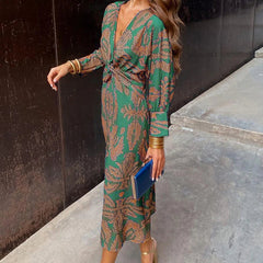 Elegant Dineke floral print dress by THE WHITMORE FAMILY, featuring a stylish, colorful design suitable for special occasions.