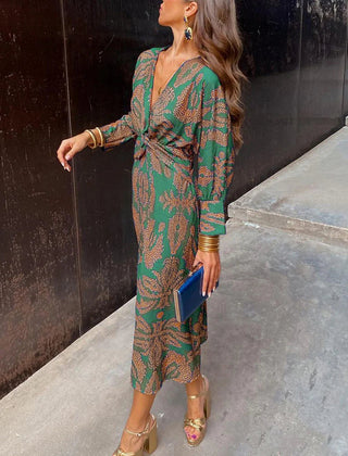Elegant Dineke floral print dress by THE WHITMORE FAMILY, featuring a stylish, colorful design suitable for special occasions.