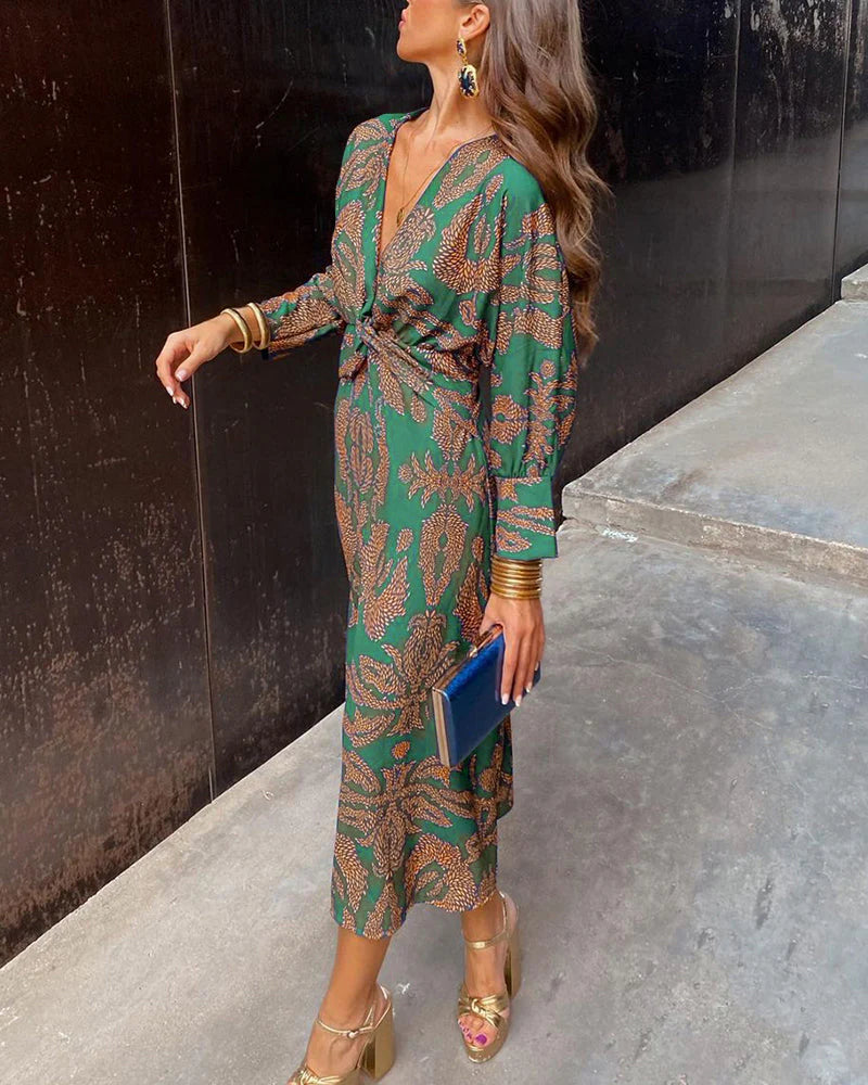Elegant Dineke floral print dress by THE WHITMORE FAMILY, featuring a stylish, colorful design suitable for special occasions.