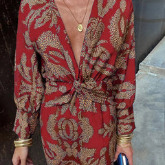 Elegant Dineke floral print dress by THE WHITMORE FAMILY, featuring a stylish design and vibrant floral pattern.