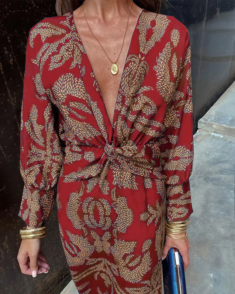 Elegant Dineke floral print dress by THE WHITMORE FAMILY, featuring a stylish design and vibrant floral pattern.