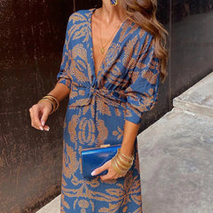 Elegant Dineke floral print dress by THE WHITMORE FAMILY, featuring a stylish design with vibrant floral patterns.