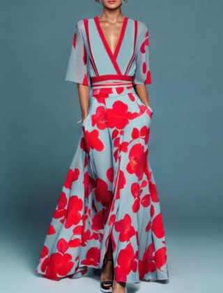 Hazel floral maxi dress by THE WHITMORE FAMILY featuring a belted waist and V-neck design, vibrant red and floral pattern.